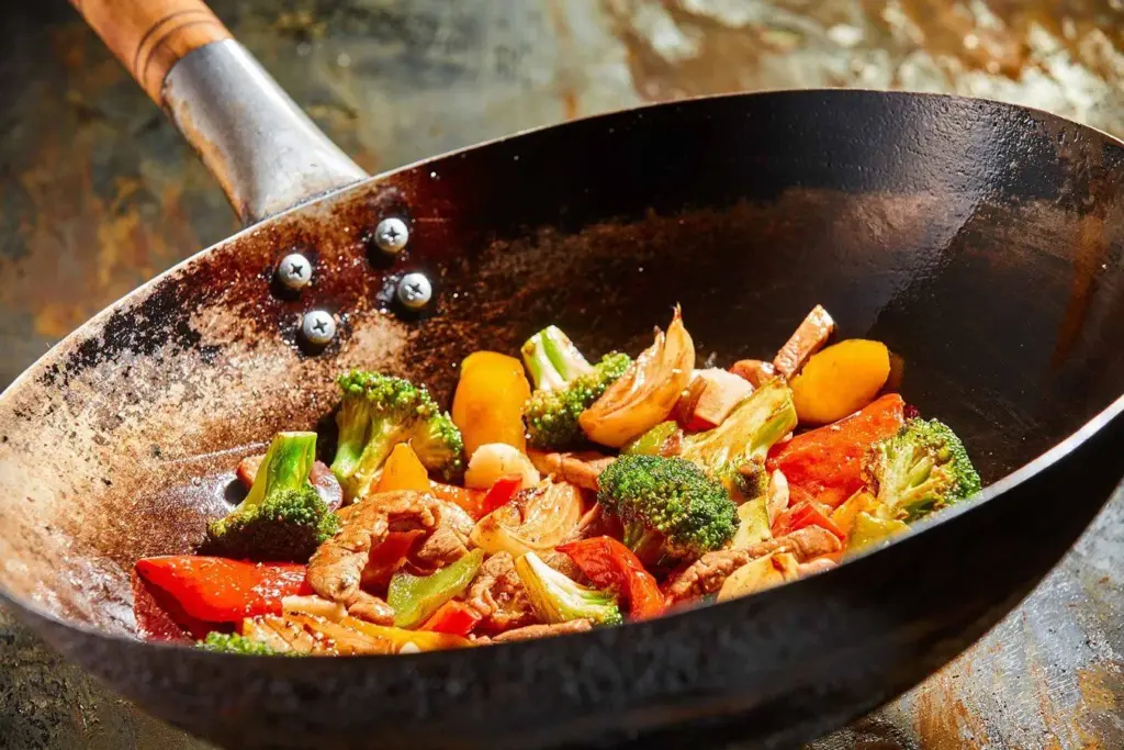 Colourful vegetables cooking in a wok