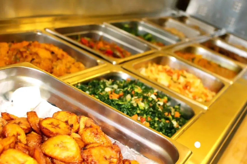 Trays of vegan Caribbean dishes at the Ital Vital counter in Scarborough
