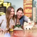 Two visitors looking at miniature Canadian scenes at Pocket Planet Canada