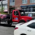 A tow truck carrying a vehicle in Toronto