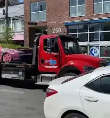 A tow truck carrying a vehicle in Toronto