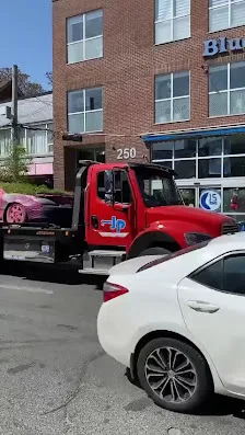 A tow truck carrying a vehicle in Toronto