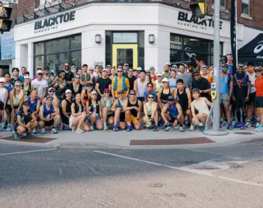 Large Toronto run club group with many women outside BlackToe Running