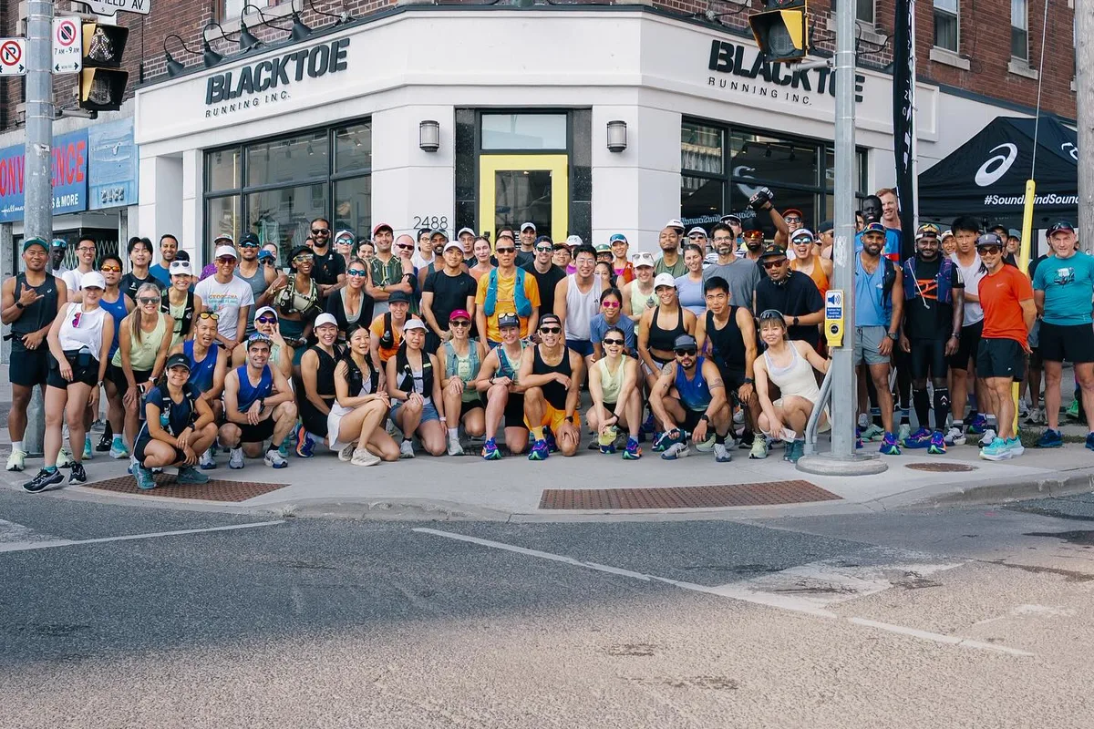 Large Toronto run club group with many women outside BlackToe Running