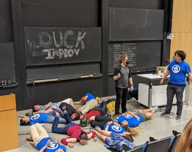 Improv performers acting out a comic scene onstage