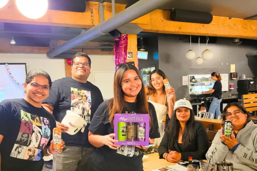 Group of women and friends smiling around a table at Snakes and Lattes Toronto