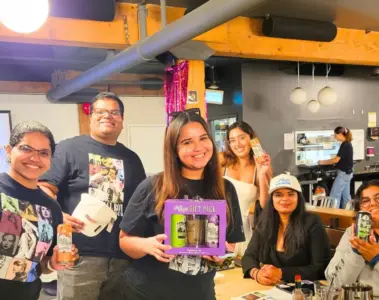 Group of women and friends smiling around a table at Snakes and Lattes Toronto