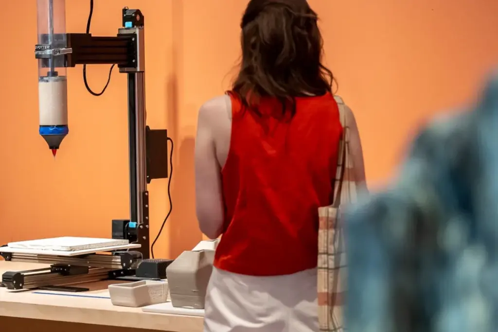 Woman exploring a contemporary ceramics display at the Gardiner Museum in Toronto