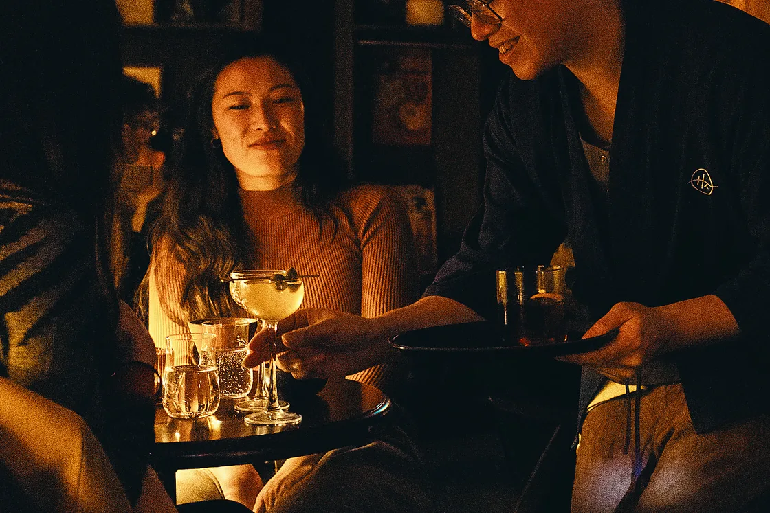 People talk over drinks in the warm interior of 915 Dupont.