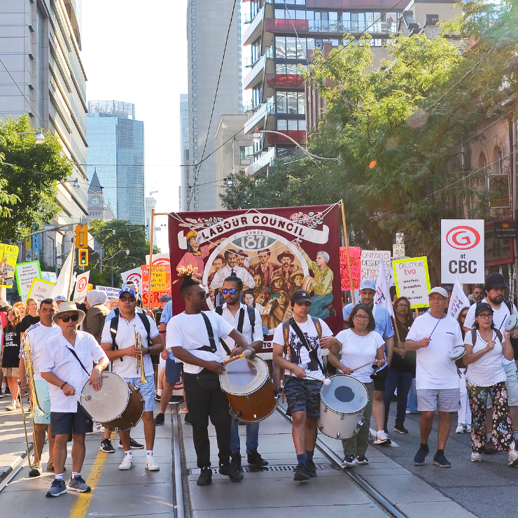 Labour Day marchers and musicians walking through downtown Toronto