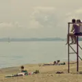 People relaxing near the lifeguard stand at Kew-Balmy Beach