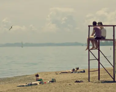 People relaxing near the lifeguard stand at Kew-Balmy Beach