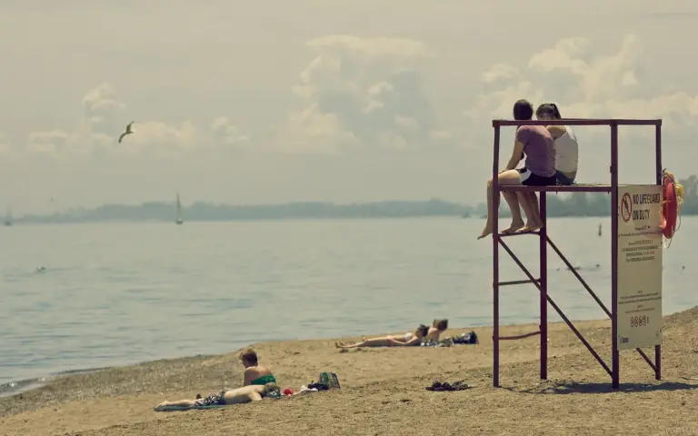 People relaxing near the lifeguard stand at Kew-Balmy Beach