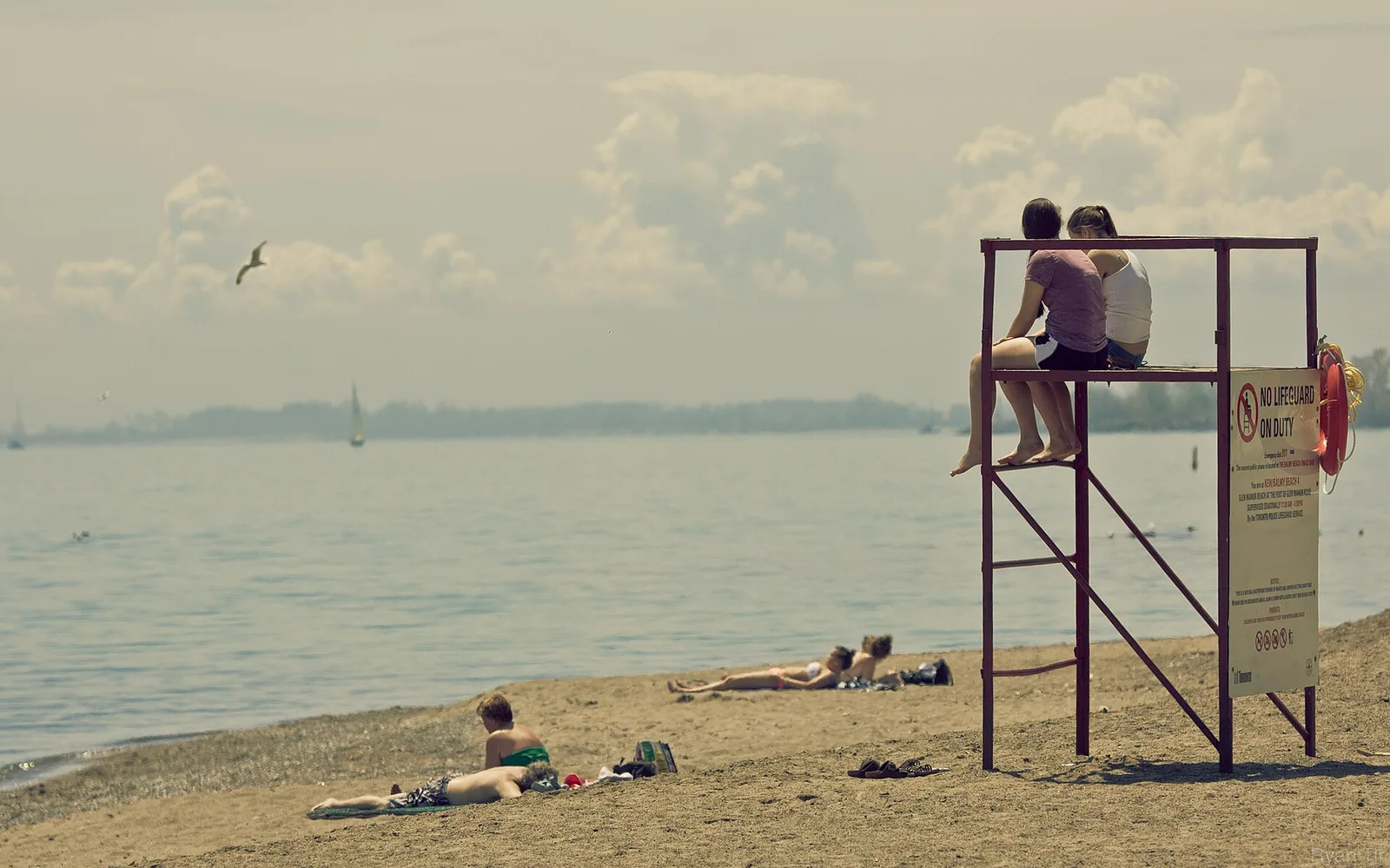 People relaxing near the lifeguard stand at Kew-Balmy Beach