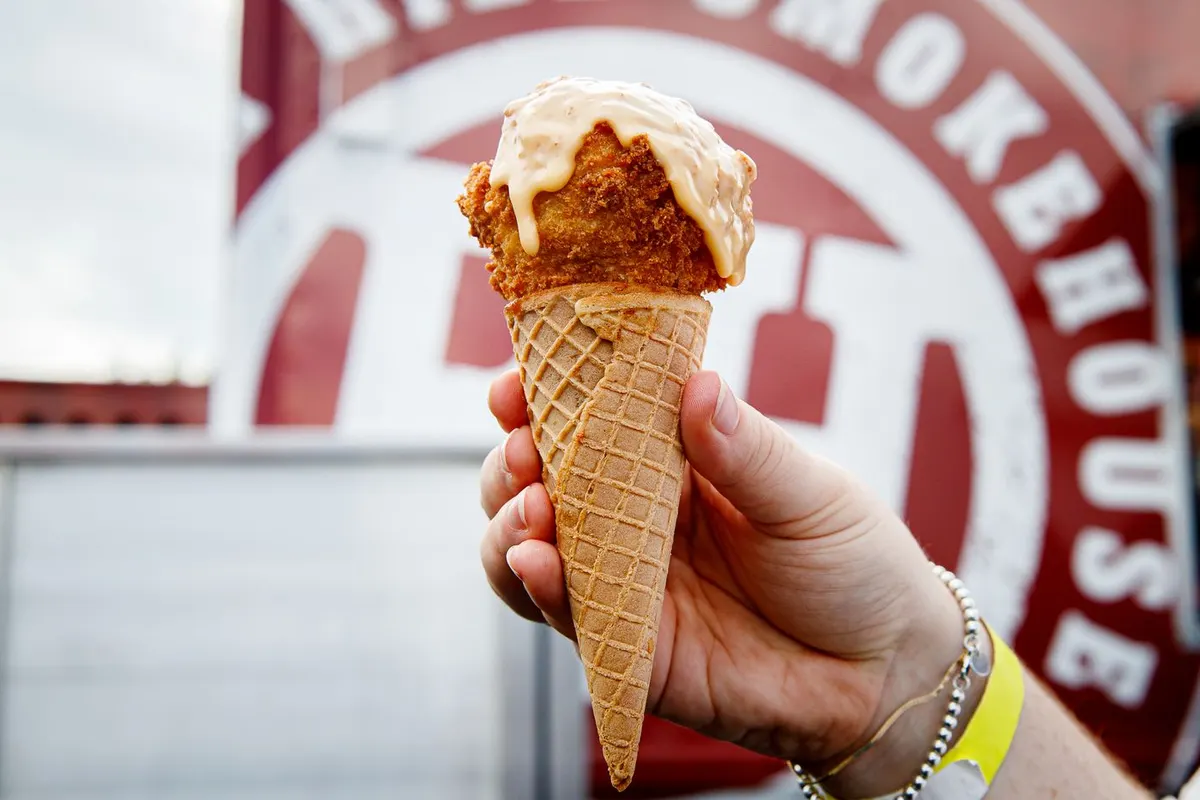Waffle cone filled with candied yams, macaroni and cheese and a fried ball