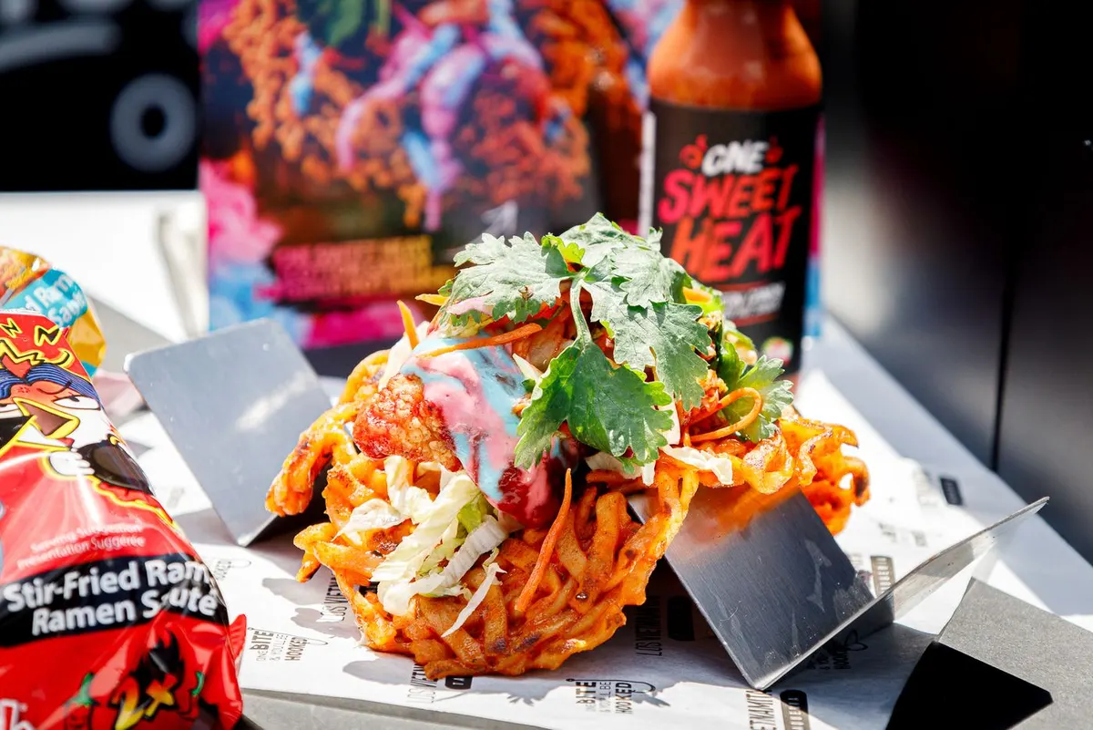 Korean fried chicken and kimchi in a crisp ramen taco shell