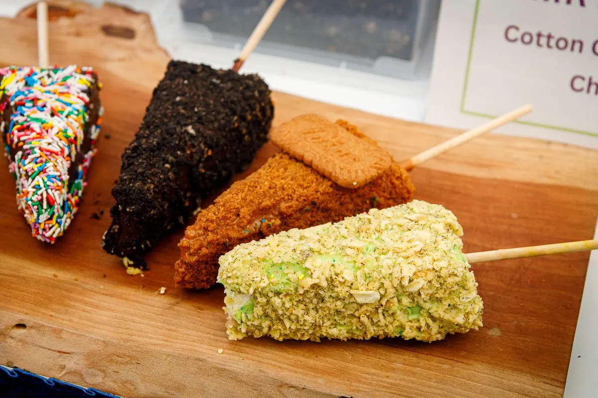 Chocolate-covered pickle cheesecake pop with dill pickle chip crumbs