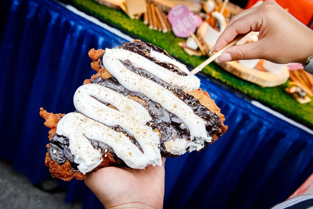 Deep fried pizza slice with marshmallow whip and chocolate drizzle