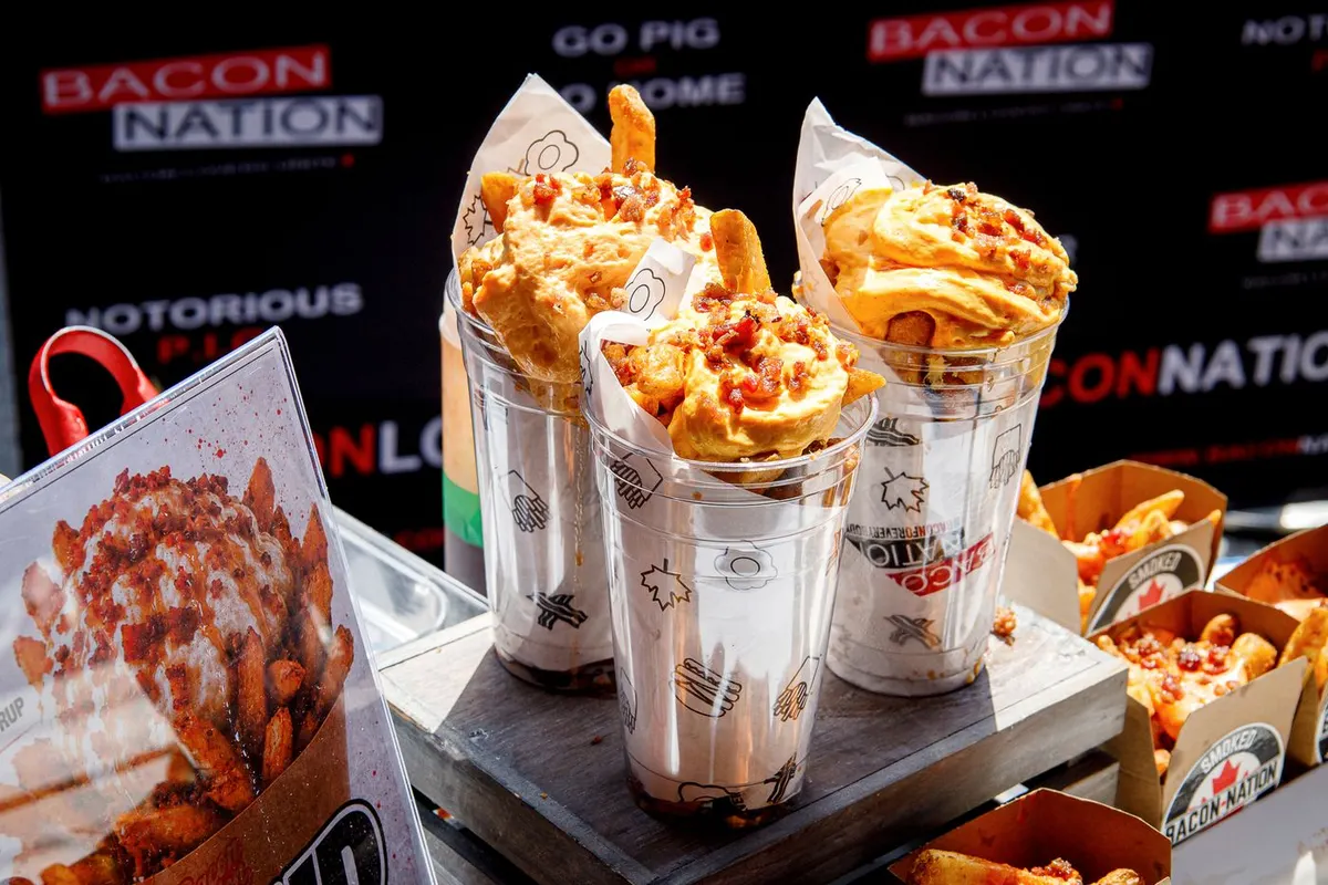 Fries topped with Sweet Heat cheese foam, bacon and maple drizzle