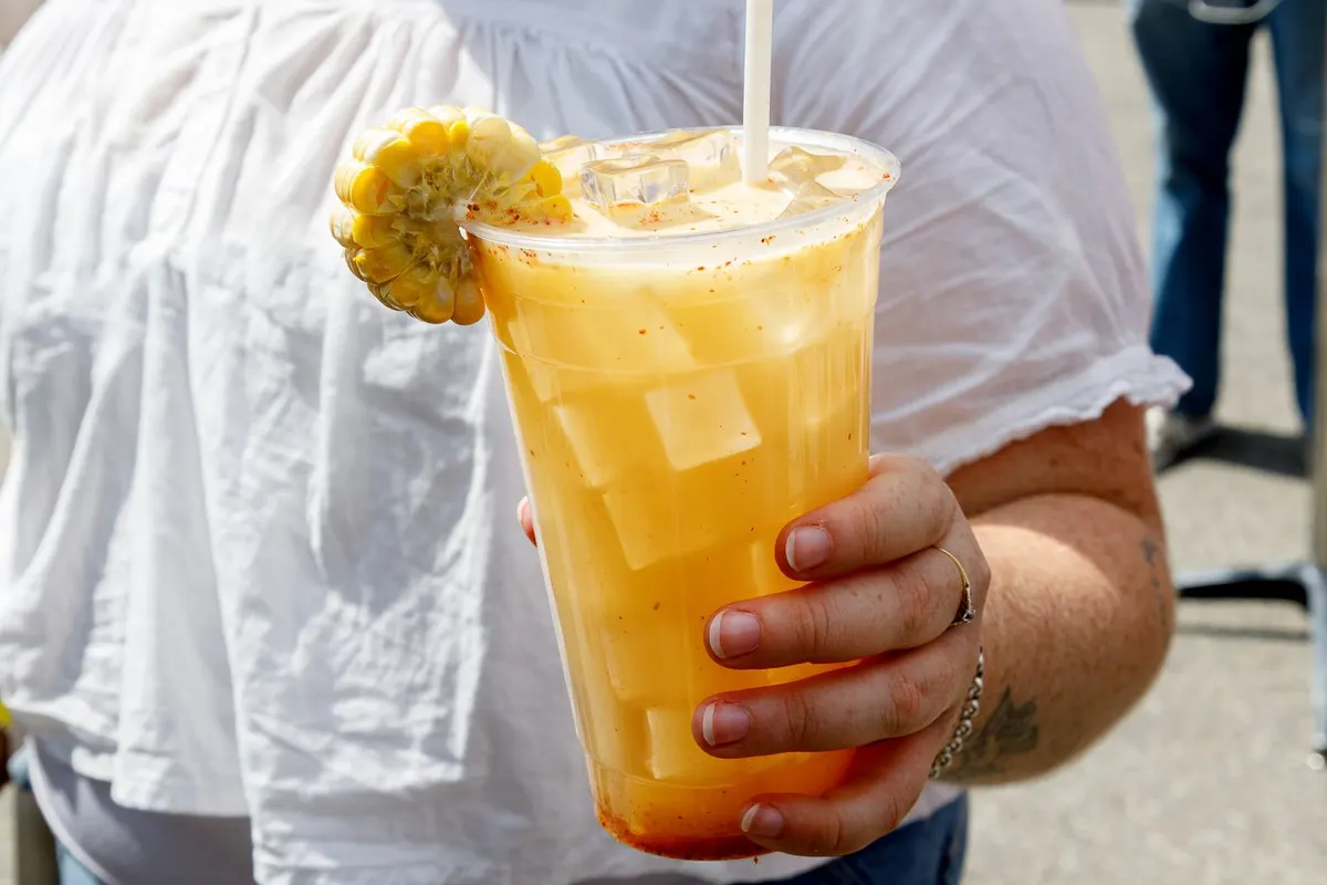Cup of sweetcorn wasabi lemonade topped with corn