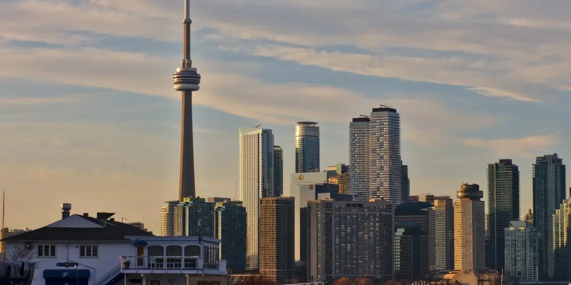 Toronto Islands shoreline, boats and homes with the downtown skyline behind them