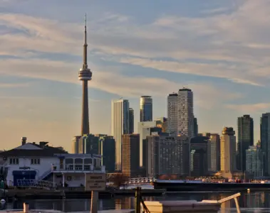 Toronto Islands shoreline, boats and homes with the downtown skyline behind them