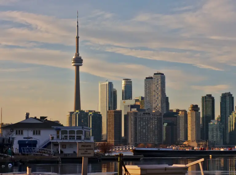 Toronto Islands shoreline, boats and homes with the downtown skyline behind them