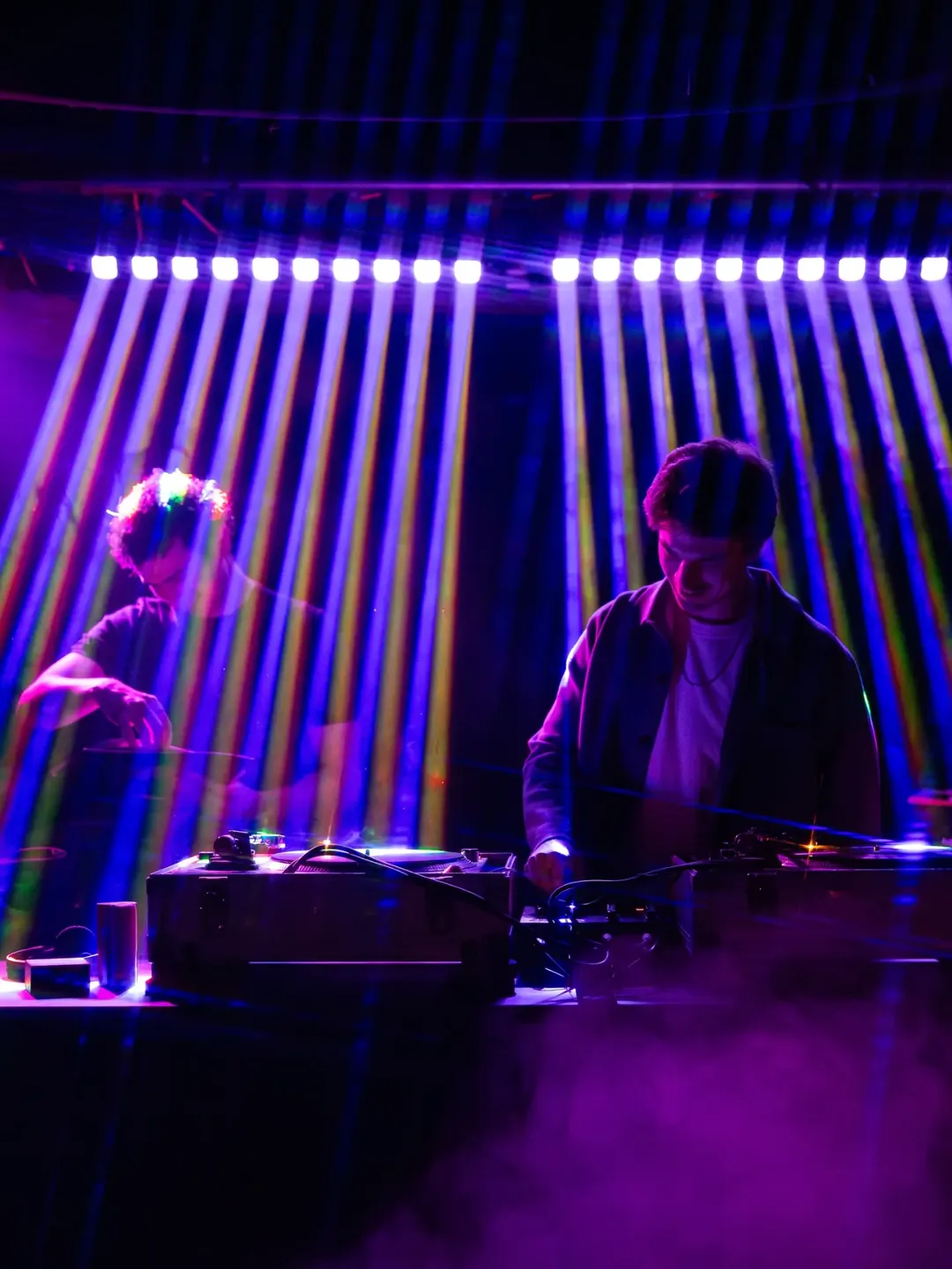 Two DJs perform under purple and blue lights at The Piston in Bloorcourt.