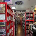 Red shelves packed with used books inside Re:Reading
