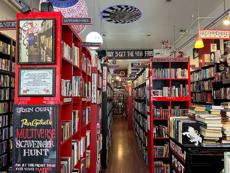 Red shelves packed with used books inside Re:Reading