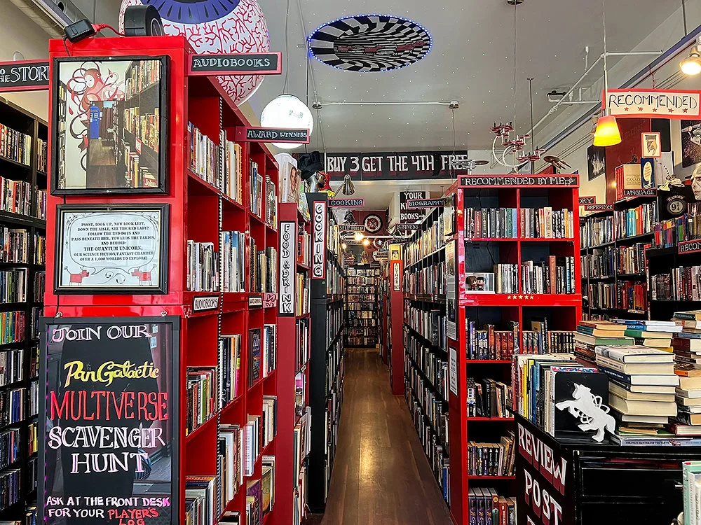 Red shelves packed with used books inside Re:Reading