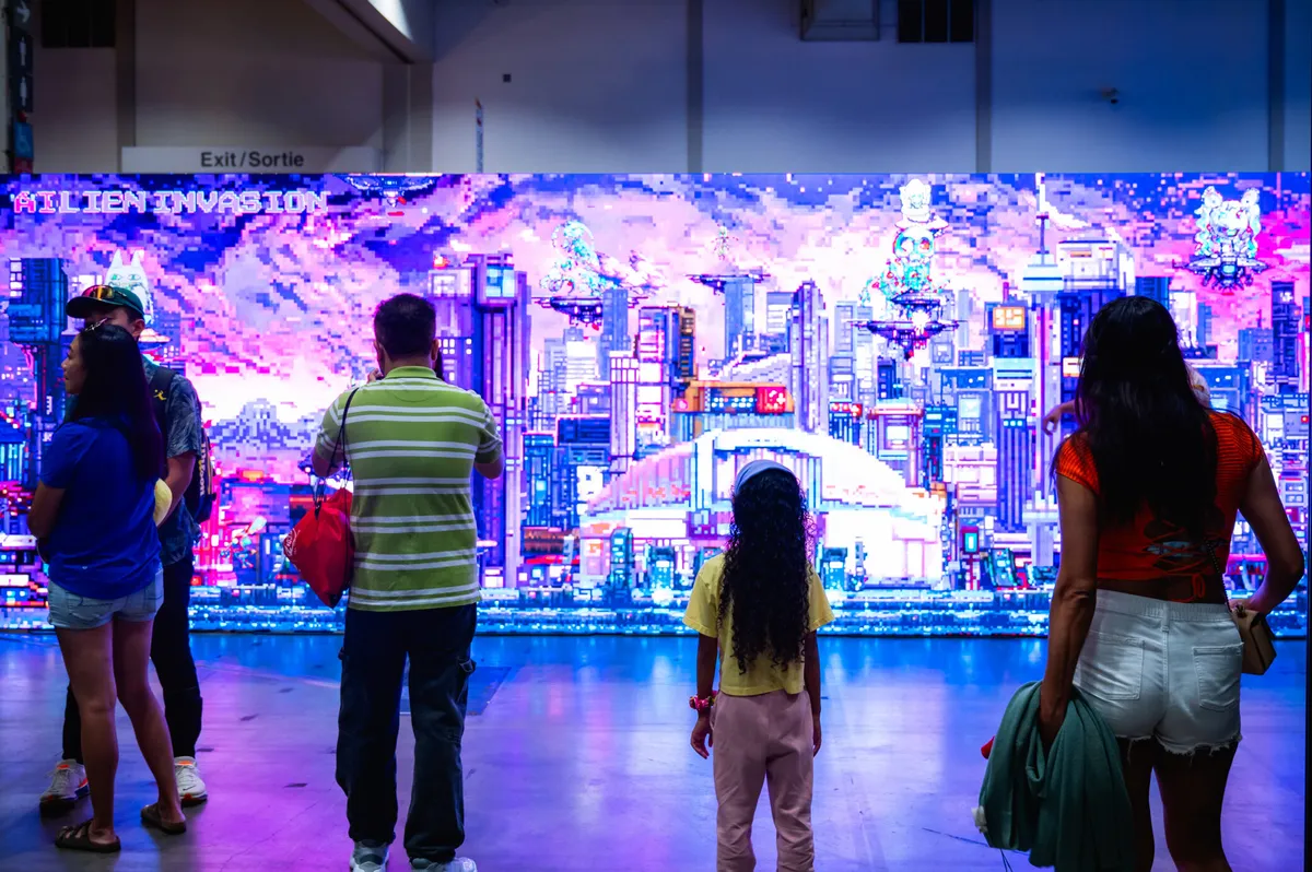 Women and families playing a large screen game at the CNE Gaming Garage