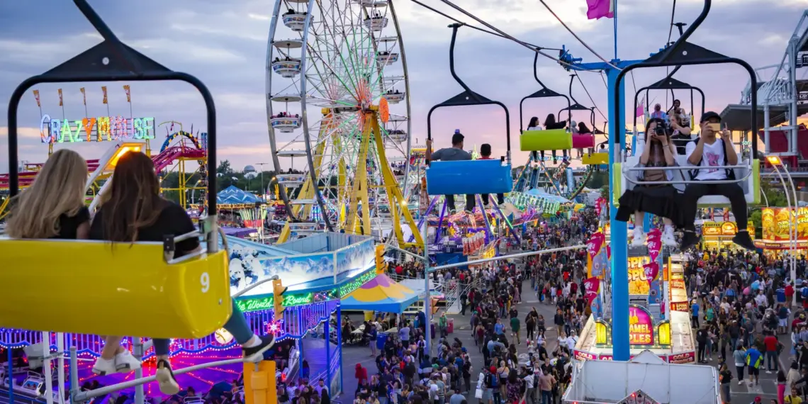 CNE midway at sunset with Ferris wheel and Sky Ride