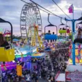 CNE midway at sunset with Ferris wheel and Sky Ride