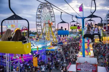 CNE midway at sunset with Ferris wheel and Sky Ride