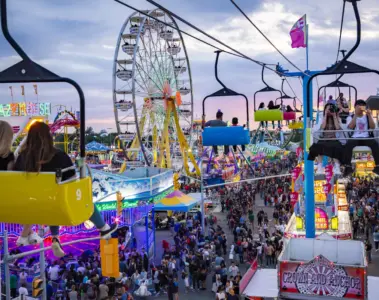 CNE midway at sunset with Ferris wheel and Sky Ride