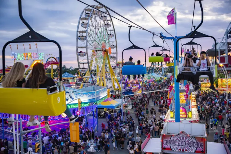 CNE midway at sunset with Ferris wheel and Sky Ride