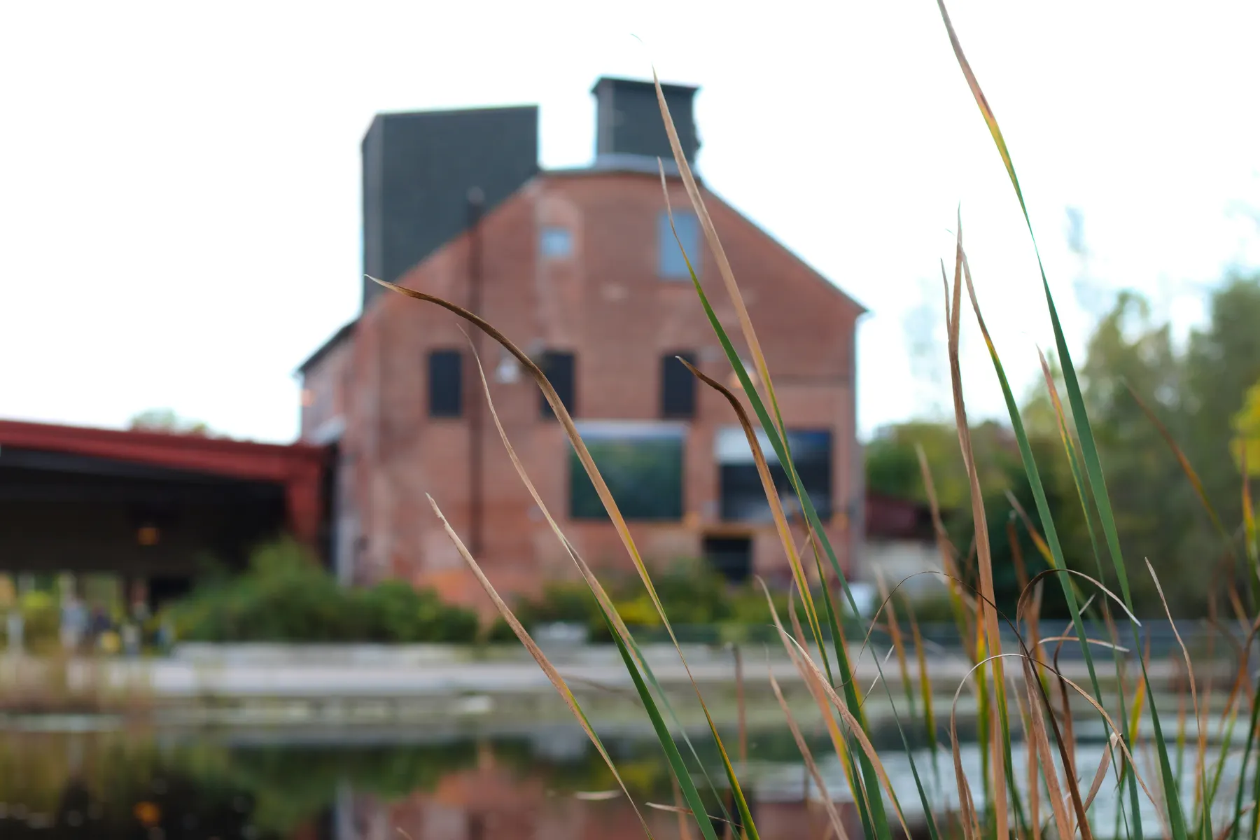 Old brick building and pond at Evergreen Brick Works in Toronto