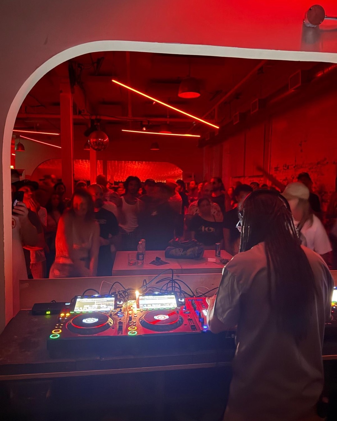 DJ performing to a packed crowd at Standard Time on Geary Avenue.