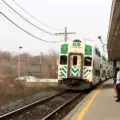 People waiting beside a GO train at Port Credit GO Station