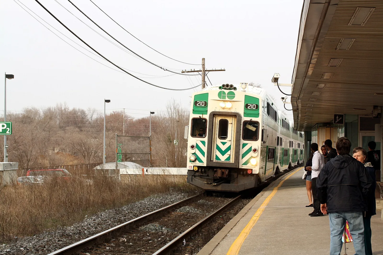 People waiting beside a GO train at Port Credit GO Station