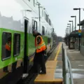 A GO employee and train at Rouge Hill GO Station