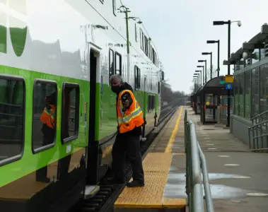 A GO employee and train at Rouge Hill GO Station