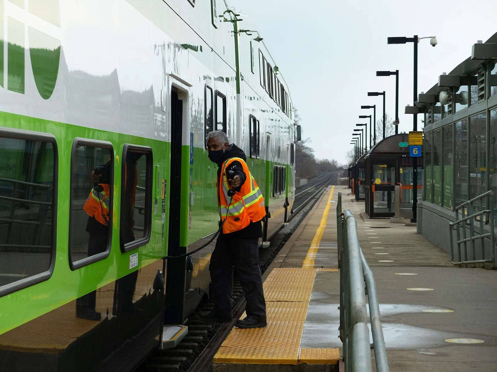 A GO employee and train at Rouge Hill GO Station