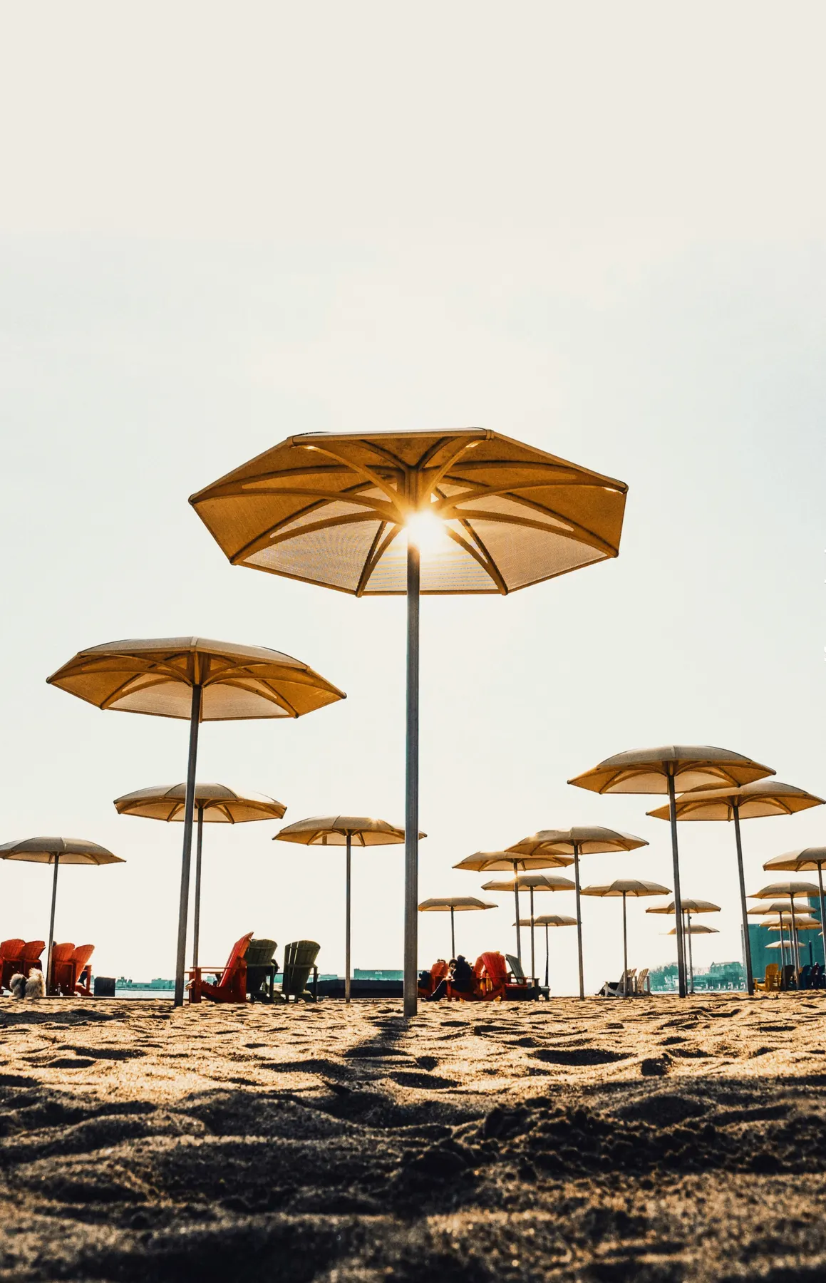 Yellow umbrellas and people relaxing on the sand at HTO Park in Toronto