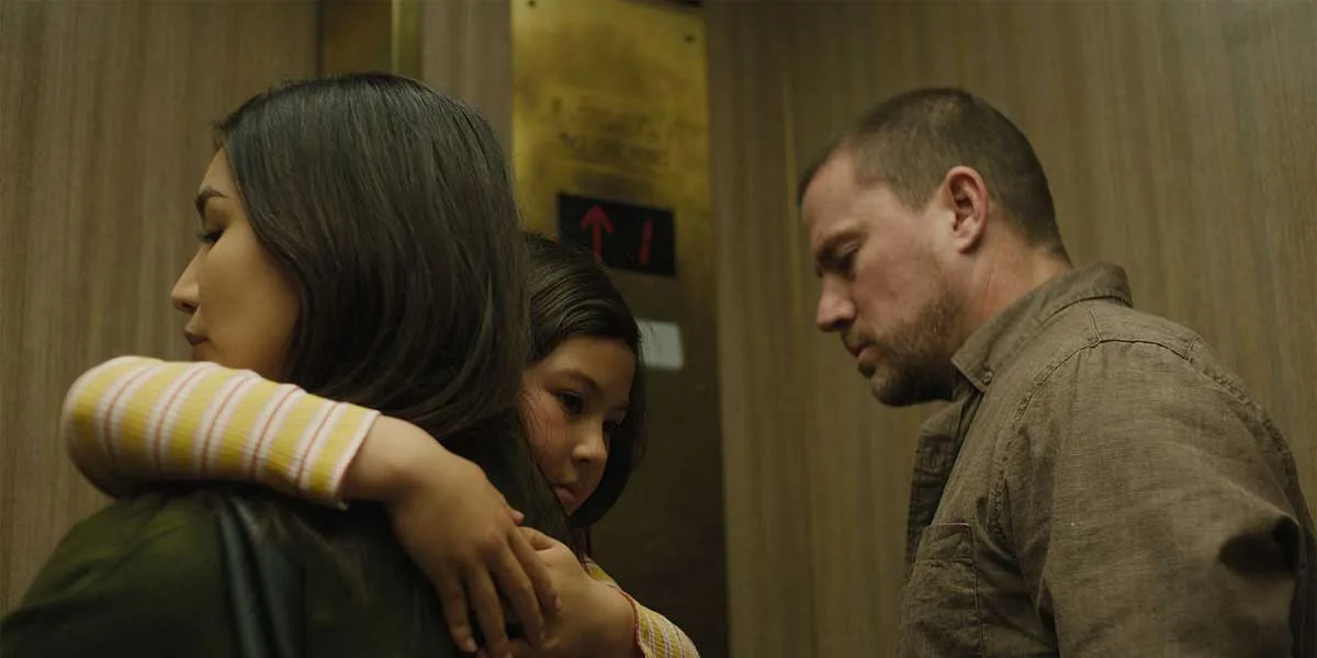 A woman holds a child in an elevator in a scene from Josephine