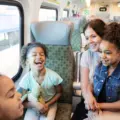 Family laughing together inside a GO train on a day trip