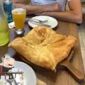 Diner sitting beside Georgian khachapuri at Tiflisi in Toronto