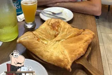 Diner sitting beside Georgian khachapuri at Tiflisi in Toronto