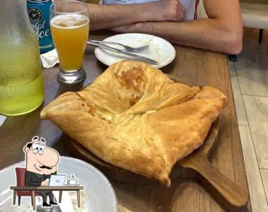 Diner sitting beside Georgian khachapuri at Tiflisi in Toronto